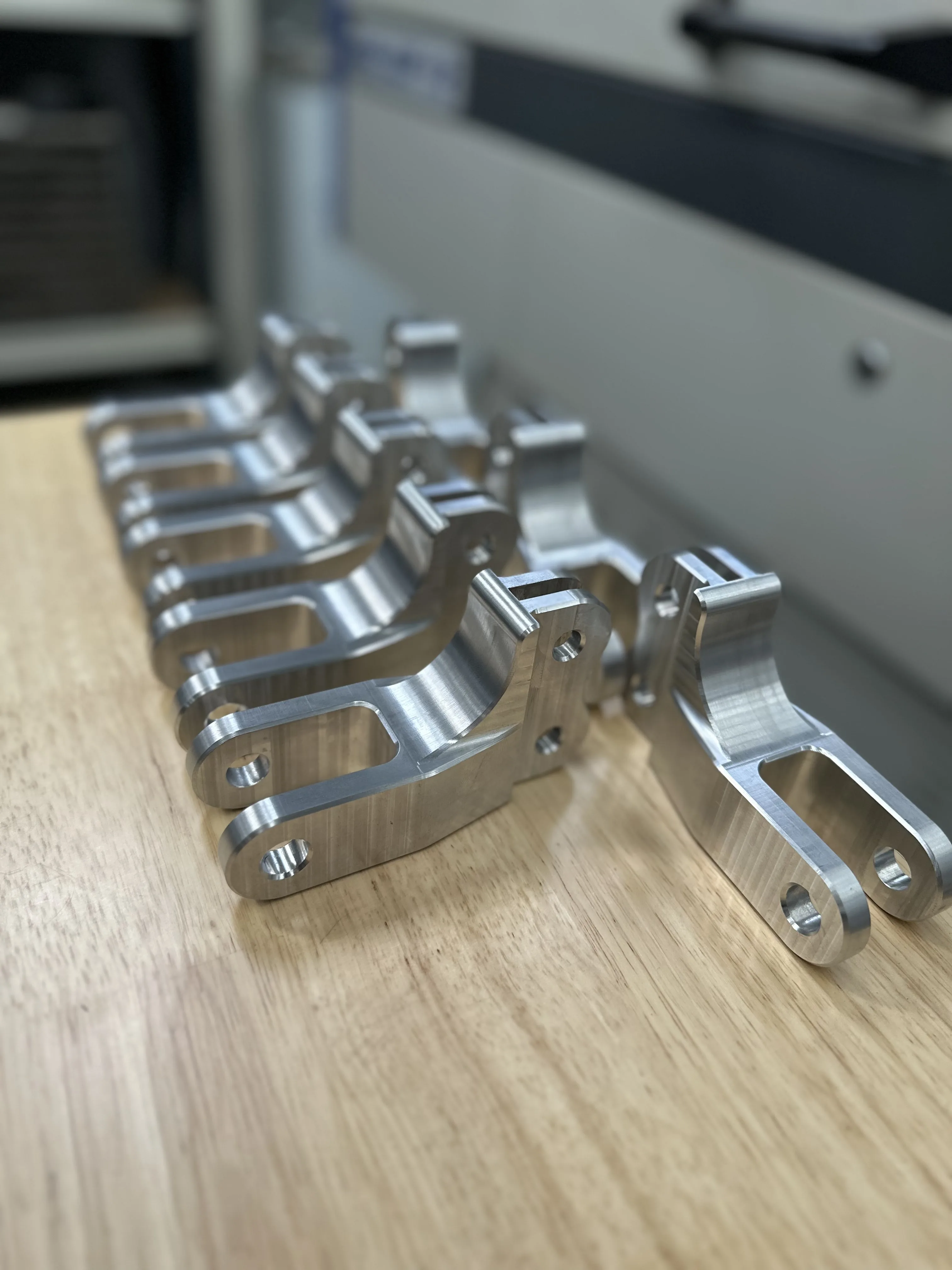 Production batch of CNC-milled aluminium brackets — consistent finish and tight tolerances, Padco Engineering