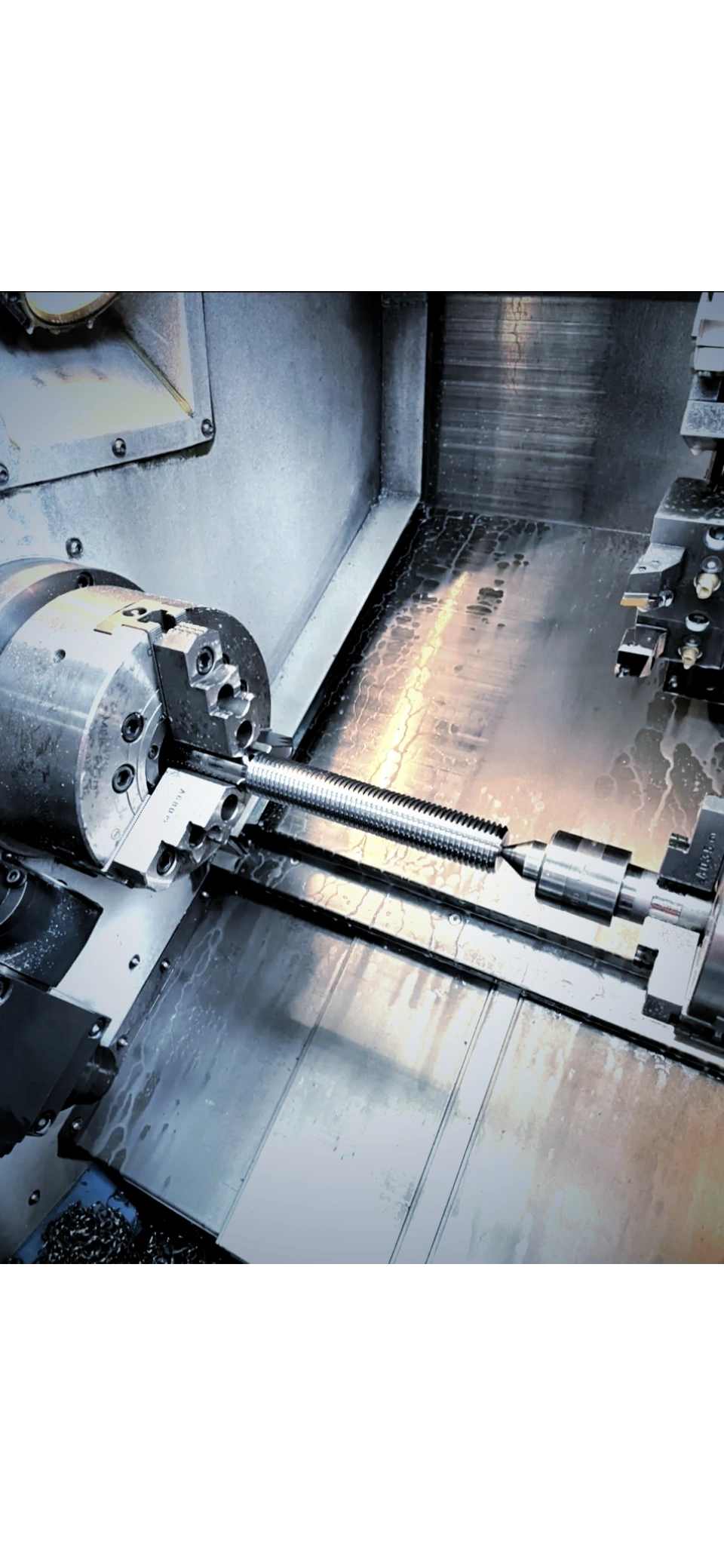 CNC lathe interior with shaft and chuck, Padco Engineering workshop