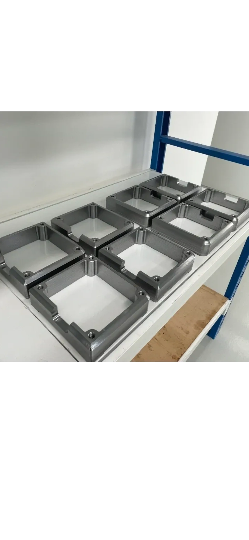 Batch of CNC milled aluminium housings on stainless bench
