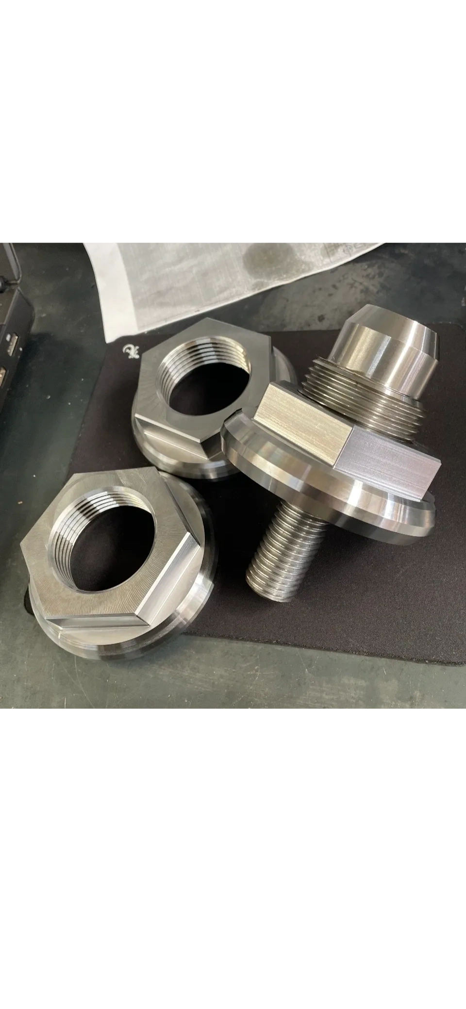 Precision machined stainless hex flange nuts and threaded fittings