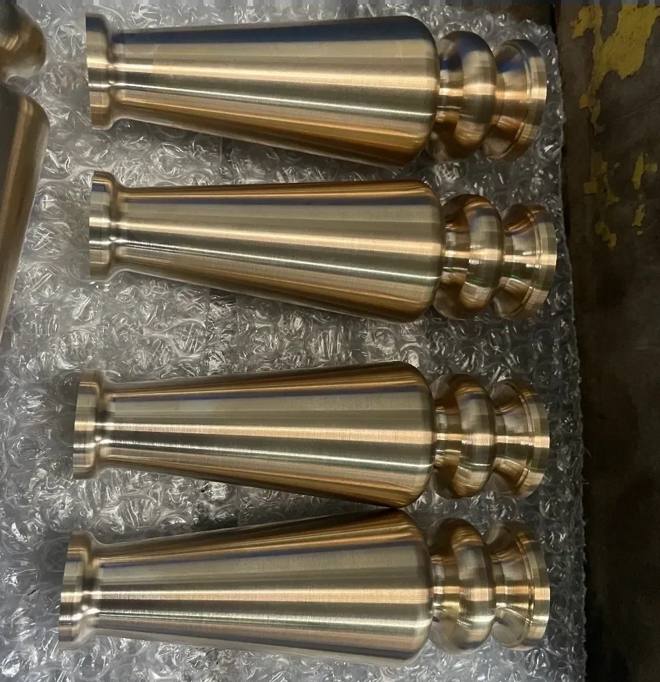 Batch of tapered brass-finish shafts with multi-step heads