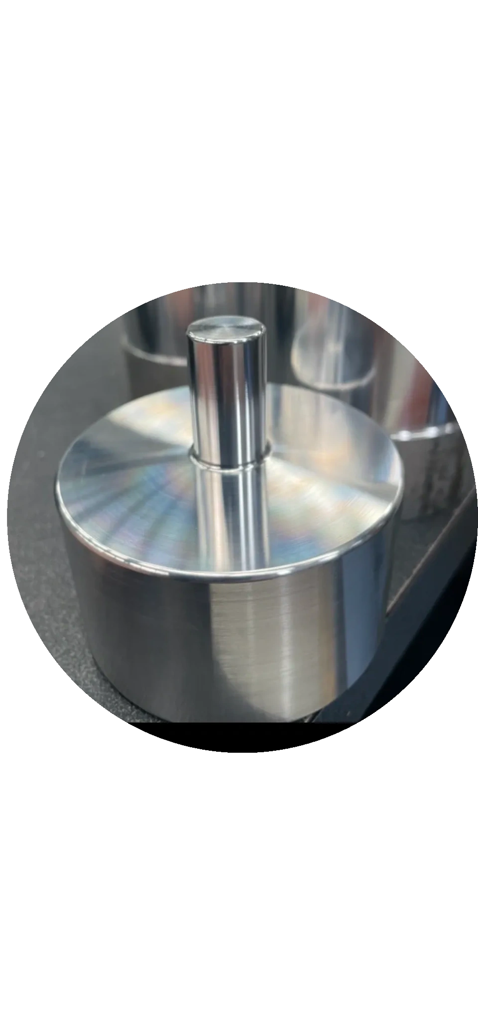 Close-up of precision turned cylindrical component with upright pin